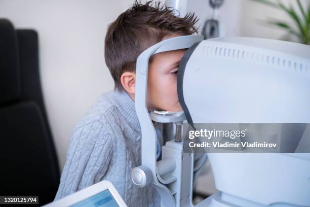 close up of a boy having his eyes tested - eye scan stock pictures, royalty-free photos & images