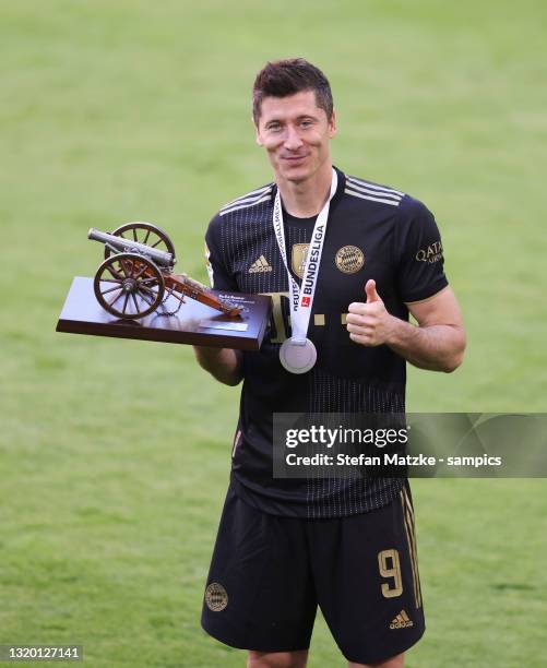 Robert Lewandowski of FC Bayern Muenchen poses with the top goalscorer of the season award following the Bundesliga match between FC Bayern Muenchen...