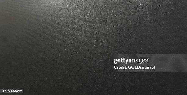 abstract panoramic black background in vector - illustration with grainy surface with delicate glow - rough structure of concrete screed with visible slightly undulating surface - abrasive paper in close up with raw uneven texture - polished concrete stock illustrations