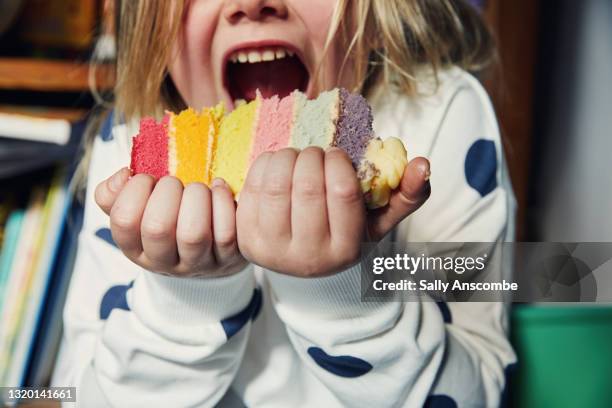 child holding a piece of birthday cake - happy birthday cake stock-fotos und bilder