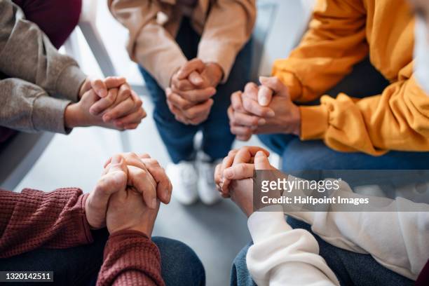 top view of group of people on therapy, praying and counselling concept. - religion stock-fotos und bilder