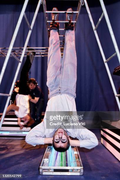 Peter Gabriel, hanging upside down on the set of an RAI TV show, Rome, Italy, 1982.