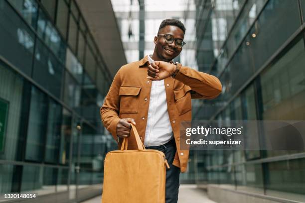 young business walking to work - checking the time stock pictures, royalty-free photos & images