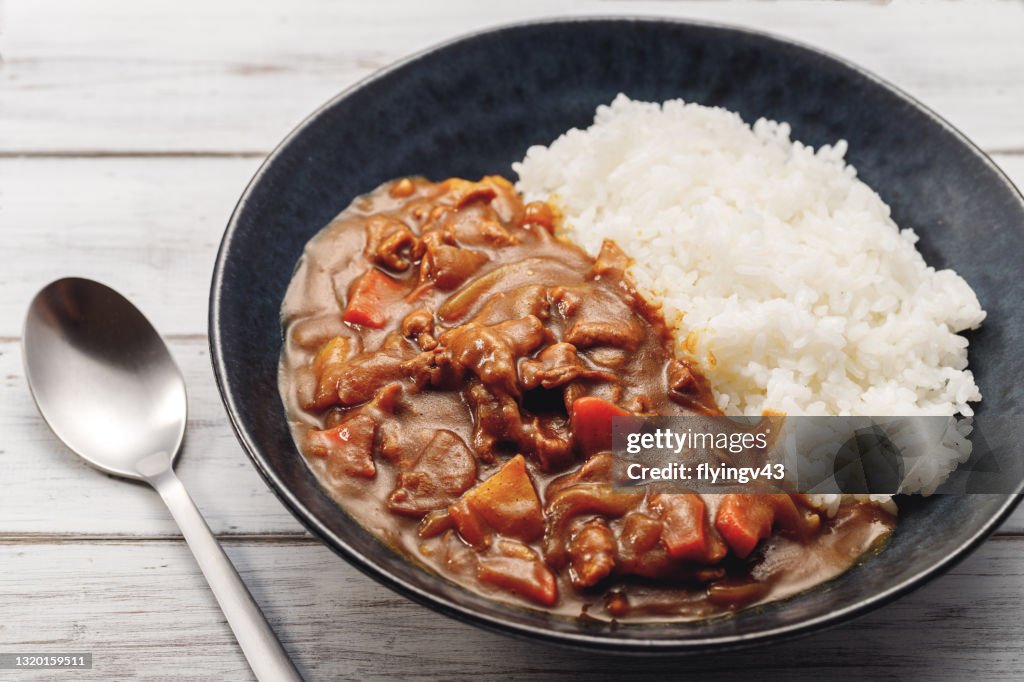 Pork curry on a black plate