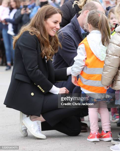Catherine, Duchess of Cambridge speaks with young children as she visits local fishermen and their families to hear about the work of fishing...