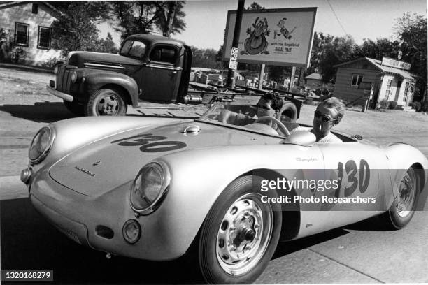 View of American actor James Dean as he and his German mechanic, Rolf Wutherich , drive in a Porsche 550 Spyder in the Sherman Oaks neighborhood, Los...