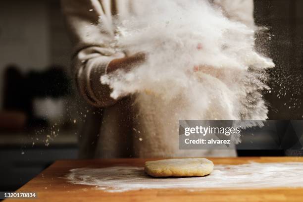 woman sprinkling flour on dough - powder puff stock pictures, royalty-free photos & images
