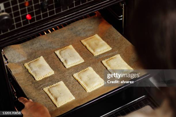 woman baking toaster pastry in oven - baked goods above stock pictures, royalty-free photos & images