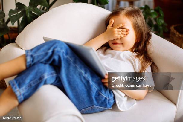 little student girl with ldigital tablet pc at home - internet danger stock pictures, royalty-free photos & images