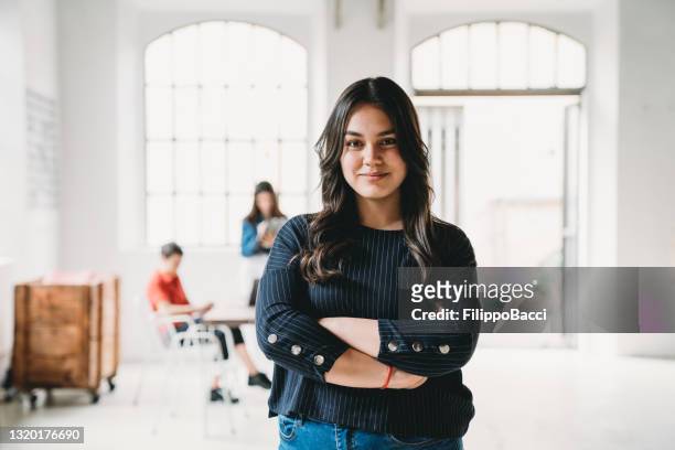 portrait of a young woman in a modern loft - founder stock pictures, royalty-free photos & images