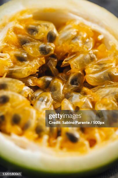 close-up of passion fruit in bowl - passion fruit stock pictures, royalty-free photos & images