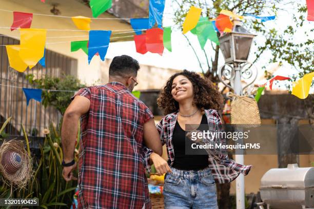 father and daughter dancing at festa junina in the backyard of their house - tradition stock pictures, royalty-free photos & images