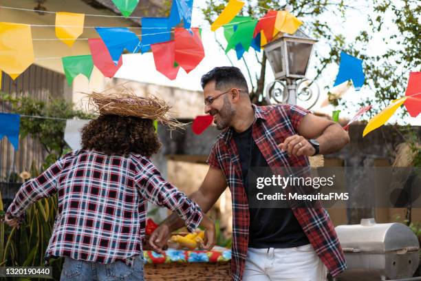 family dancing at festa junina in the backyard of their house - square dancing stock pictures, royalty-free photos & images