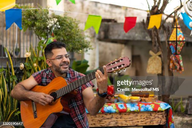 man playing guitar at festa junina - traditional festival imagens e fotografias de stock
