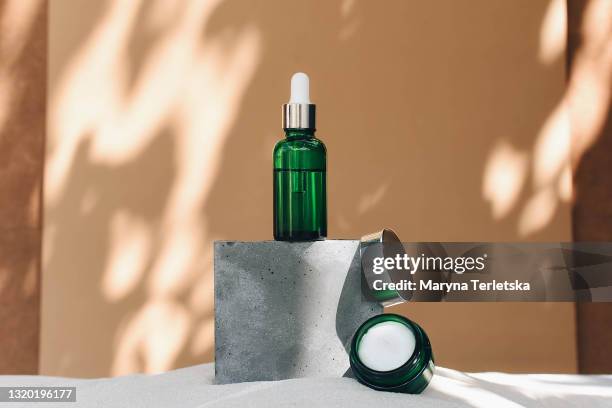 containers with natural cosmetics in a stylish concept. - green serum stock pictures, royalty-free photos & images