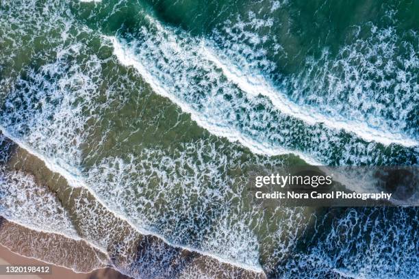 drone point of view of a waves and beach - alta marea foto e immagini stock
