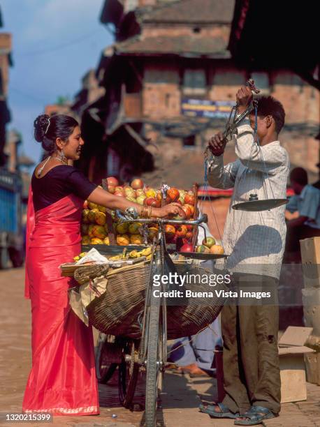 nepalese woman buying fruits in a street - nepal food stock pictures, royalty-free photos & images