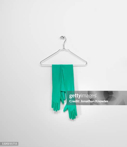 green gloves on hanger - coathanger stock pictures, royalty-free photos & images