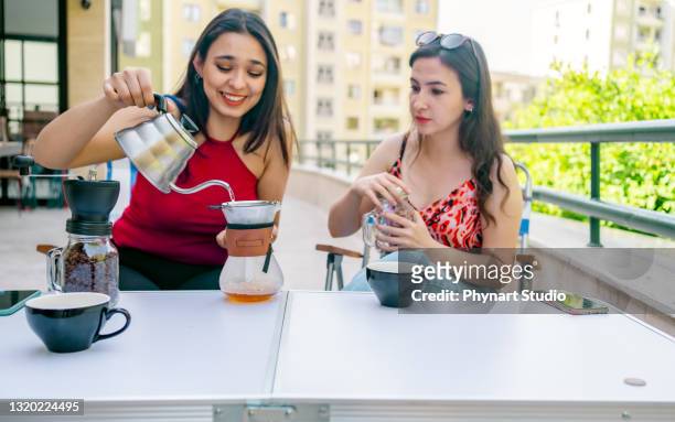 women preparing coffee using glass coffeemaker pour over coffee maker and drip kettle - coffee plunger stock pictures, royalty-free photos & images