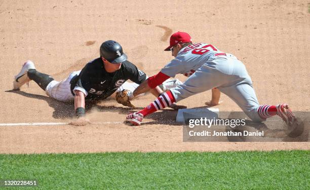 Andrew Vaughn of the Chicago White Sox gets his hand on third base before Max Moroff of the St. Louis Cardinals can apply the tag in the 6th inning...