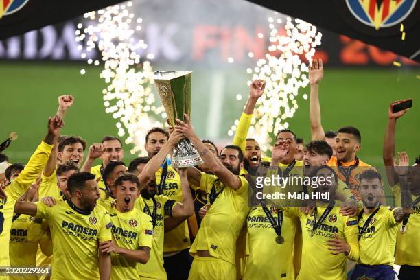 Mario and Raul Albiol of Villarreal CF lift the UEFA Europa League Trophy as their team mates celebrate following victory in the UEFA Europa League...