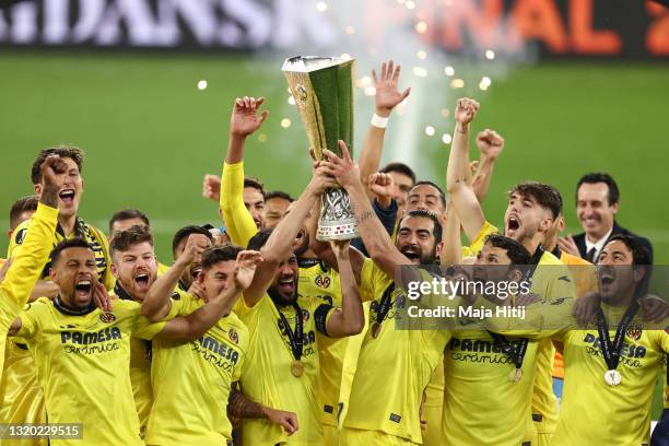 Mario and Raul Albiol of Villarreal CF lift the UEFA Europa League Trophy as their team mates celebrate following victory in the UEFA Europa League...