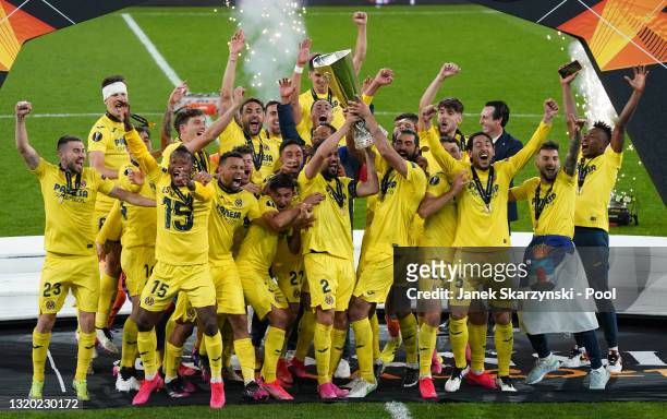 Mario and Raul Albiol of Villarreal lift the UEFA Europa League Trophy following victory in the UEFA Europa League Final between Villarreal CF and...