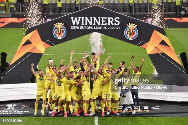 Mario and Raul Albiol of Villarreal CF lift the UEFA Europa League Trophy as their team mates celebrate following victory in the UEFA Europa League...