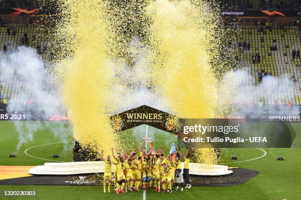 Mario and Raul Albiol of Villarreal CF lift the UEFA Europa League Trophy as their team mates celebrate following victory in the UEFA Europa League...