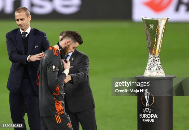 David de Gea of Manchester United makes their way past the UEFA Europa League Trophy following the UEFA Europa League Final between Villarreal CF and...