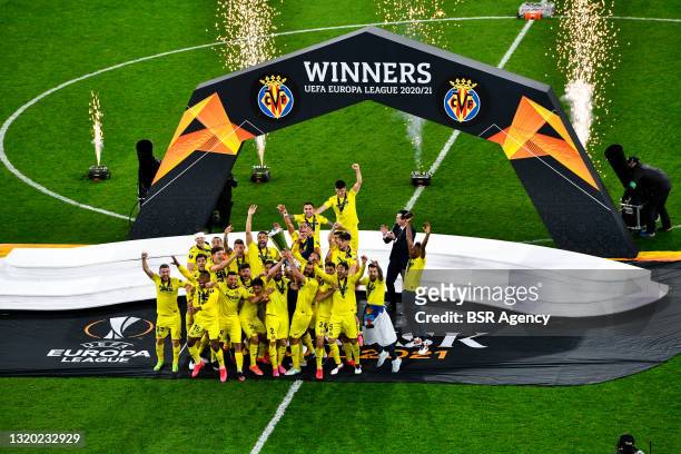 Mario and Raul Albiol of Villarreal CF lift the UEFA Europa League Trophy as their team mates celebrate following victory during the UEFA Europa...