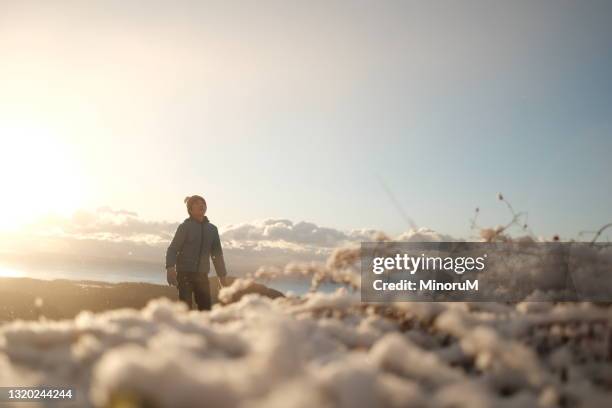 boy looking up the sky in the snowy day - every cloud has a silver lining stock pictures, royalty-free photos & images