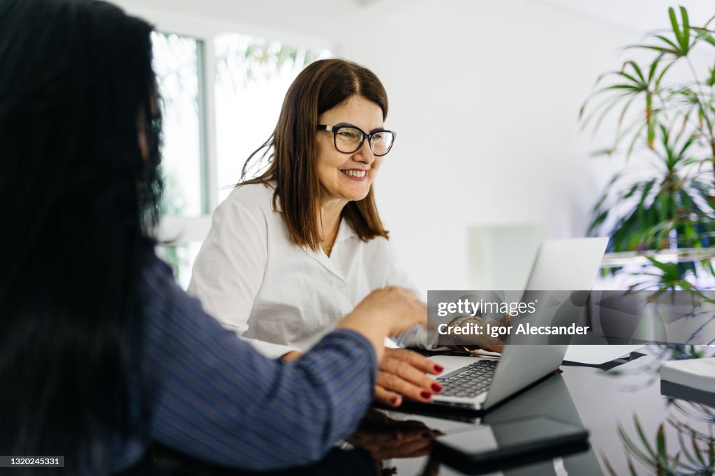 Bank manager showing data to customer