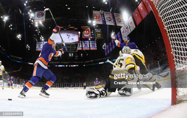 Kyle Palmieri of the New York Islanders celebrates his goal at 12:25 of the first period against Tristan Jarry of the Pittsburgh Penguins and is...