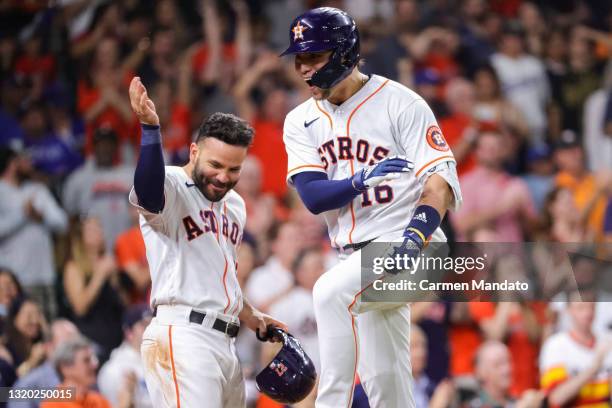 Aledmys Diaz of the Houston Astros reacts with Jose Altuve after hitting a two run home run during the seventh inning against the Los Angeles Dodgers...