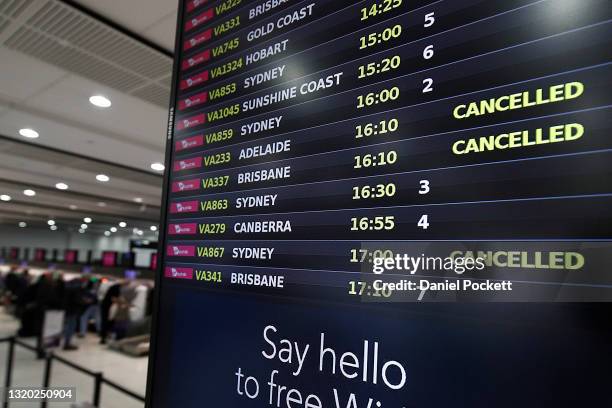 Flight board at the Virgin domestic departures terminal of Melbourne Airport is seen, displaying cancelled flights on May 27, 2021 in Melbourne,...