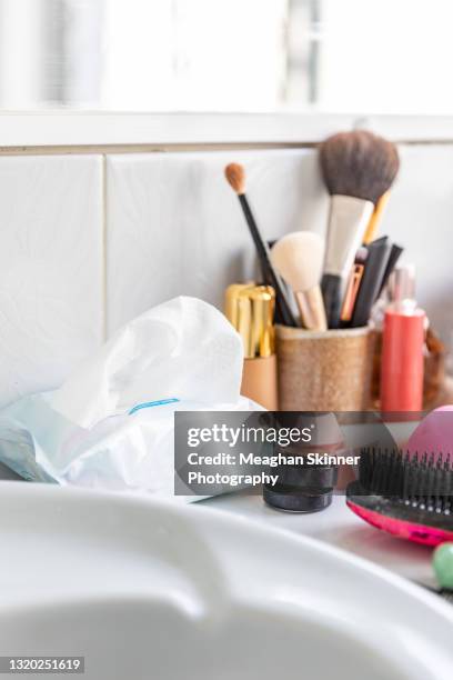 messy cosmetics displayed in a bathroom - messy medicine cabinet stock pictures, royalty-free photos & images