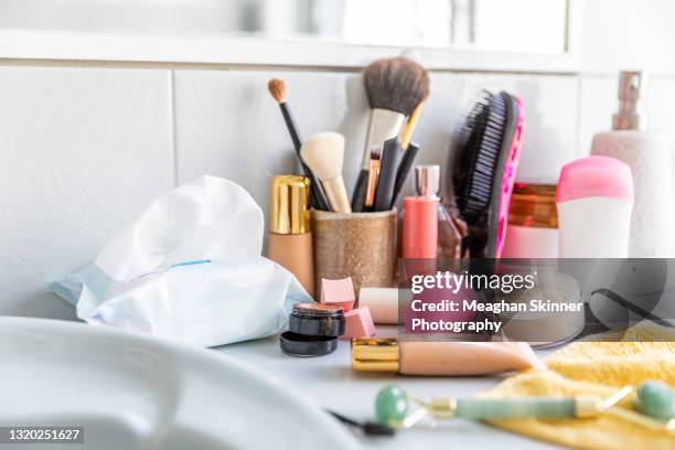 messy cosmetics displayed in a bathroom - theaterschminke stock-fotos und bilder