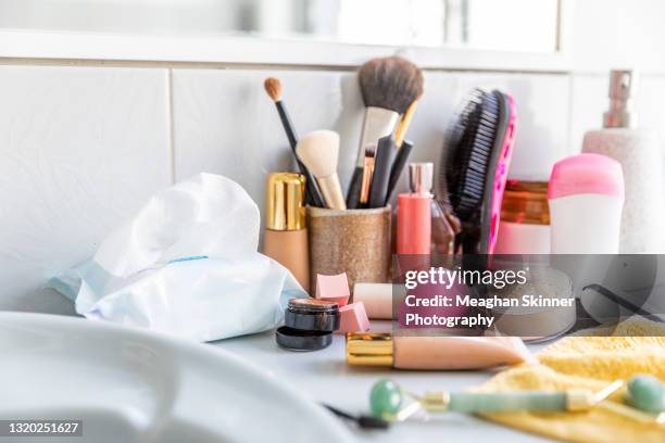 messy cosmetics displayed in a bathroom - make up bag fotografías e imágenes de stock