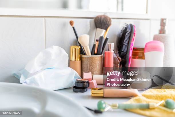 messy cosmetics displayed in a bathroom - cermoniell ansiktsmålning bilder bildbanksfoton och bilder