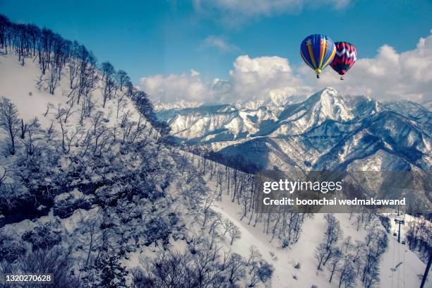 colorful hot-air balloon flying over snowcapped mountain - ジャム・カシミール州 ストックフォトと画像