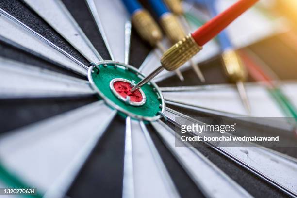 red three darts arrows in the target center business goal concept double exposure with cityscape building - arranging stock pictures, royalty-free photos & images