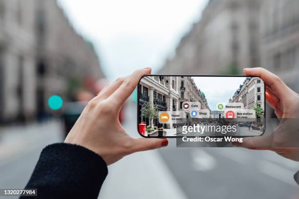 finding direction with augmented reality on smartphone on street - realtà aumentata foto e immagini stock