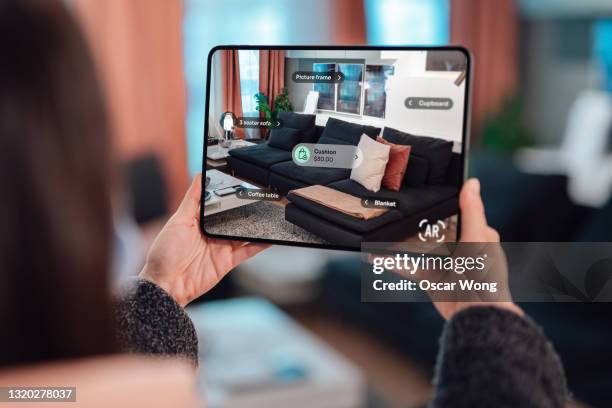 checking product information with augmented reality on tablet at furniture store - back of sofa stock pictures, royalty-free photos & images