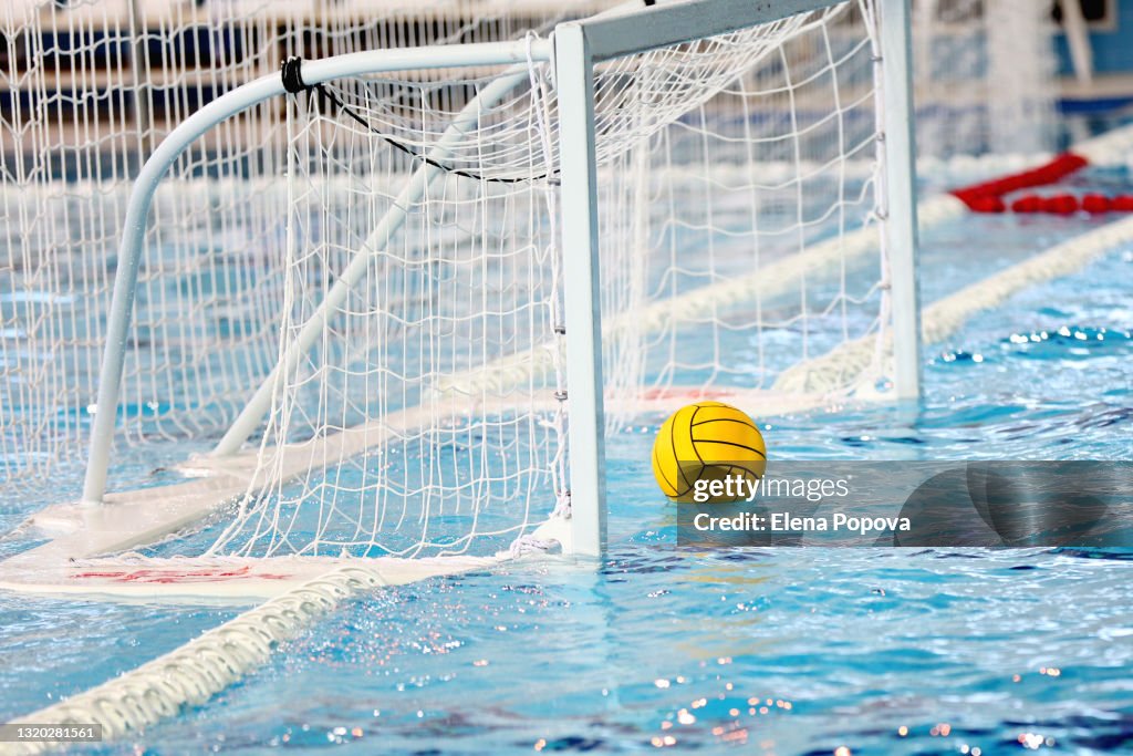 Yellow Water Polo Ball Floating On The Water Into Water Polo Goal Net