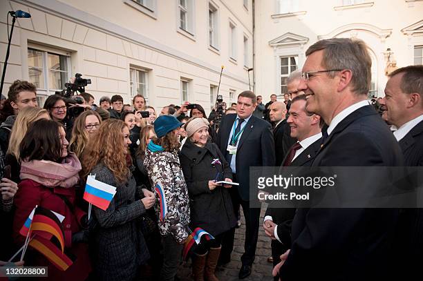 In this photo provided by the German Government Press Office German President Christian Wulff and Russian President Dmitry Medvedev greet spectators...