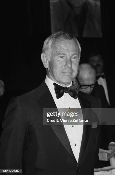 American television presenter and comedian Johnny Carson , wearing a tuxedo and bow tie, attends the Friars Club ceremony where Burt Reynolds was...