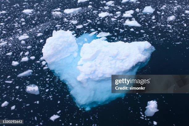 iceberg and ice floating on sea water - glacial ice sheet stock pictures, royalty-free photos & images