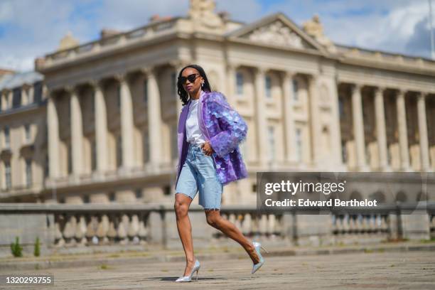 Emilie Joseph @in_fashionwetrust wears black sunglasses, a crystal earring by Swarovski Giovanna Engelbert , a crystal matching ring, a white...