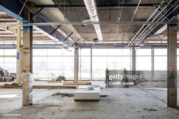workers at construcion site - building interior stock pictures, royalty-free photos & images